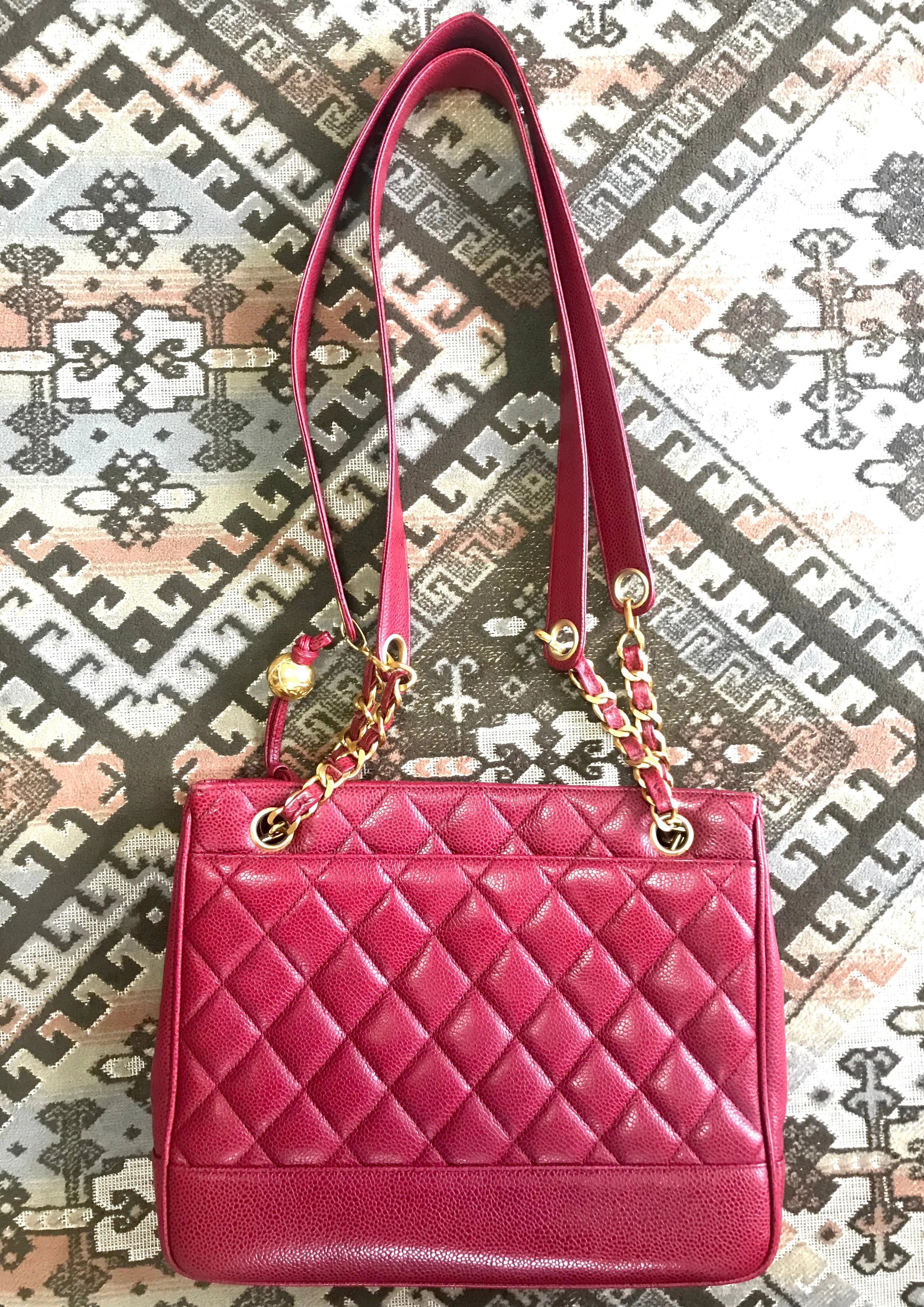 Vintage CHANEL cherry red caviar leather quilted shoulder bag, tote with golden CC ball and chain straps. Classic bag.