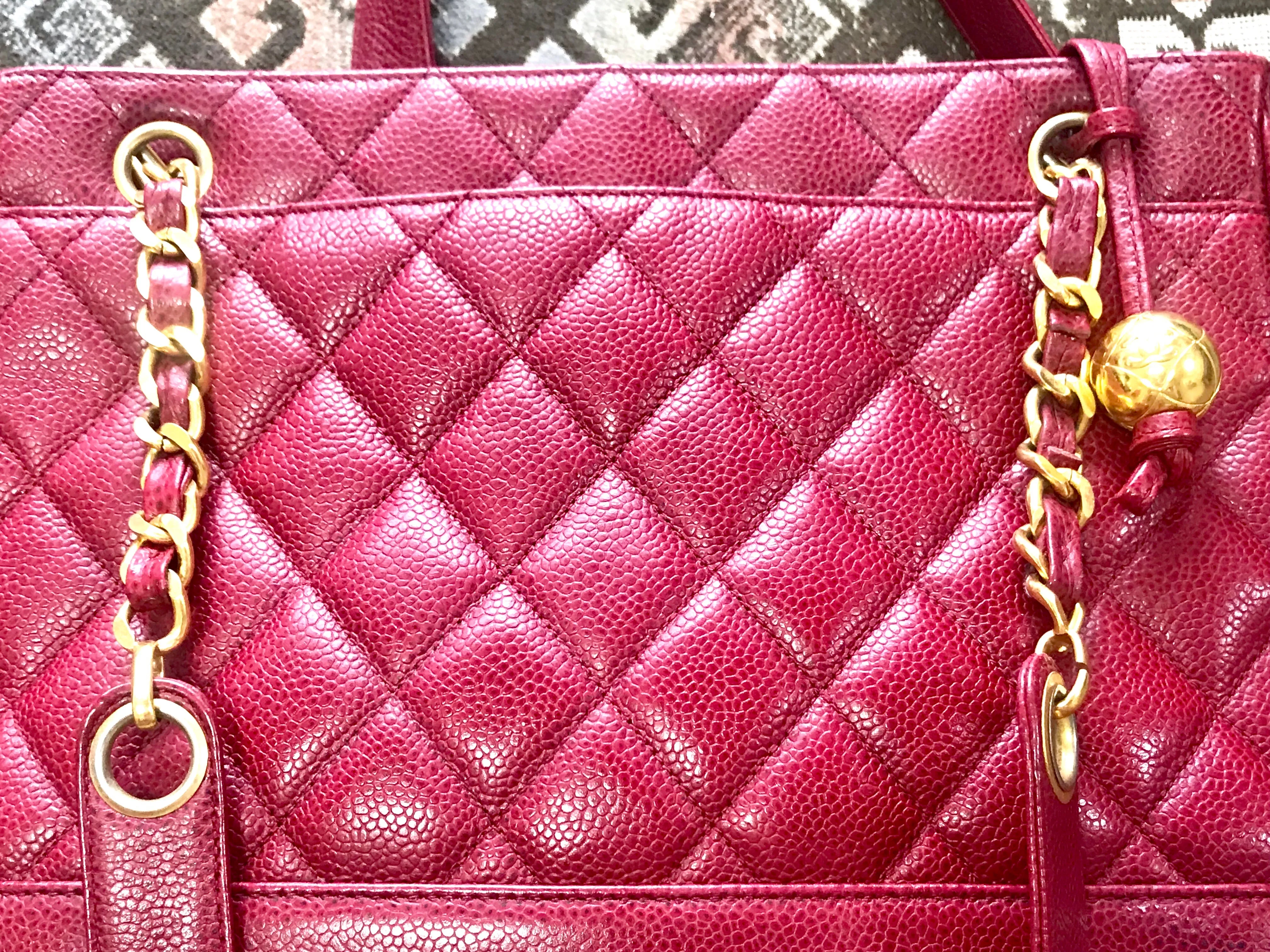 Vintage CHANEL cherry red caviar leather quilted shoulder bag, tote with golden CC ball and chain straps. Classic bag.