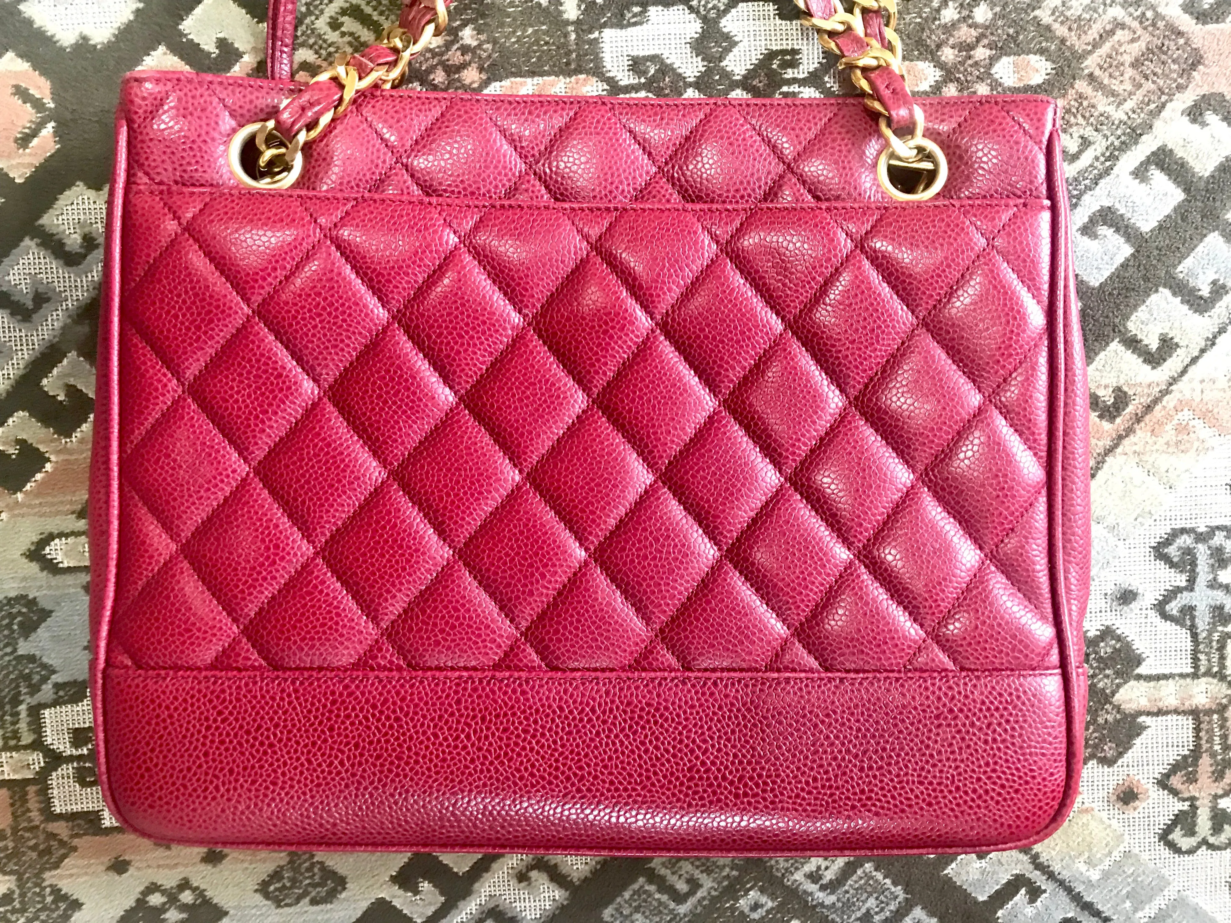 Vintage CHANEL cherry red caviar leather quilted shoulder bag, tote with golden CC ball and chain straps. Classic bag.