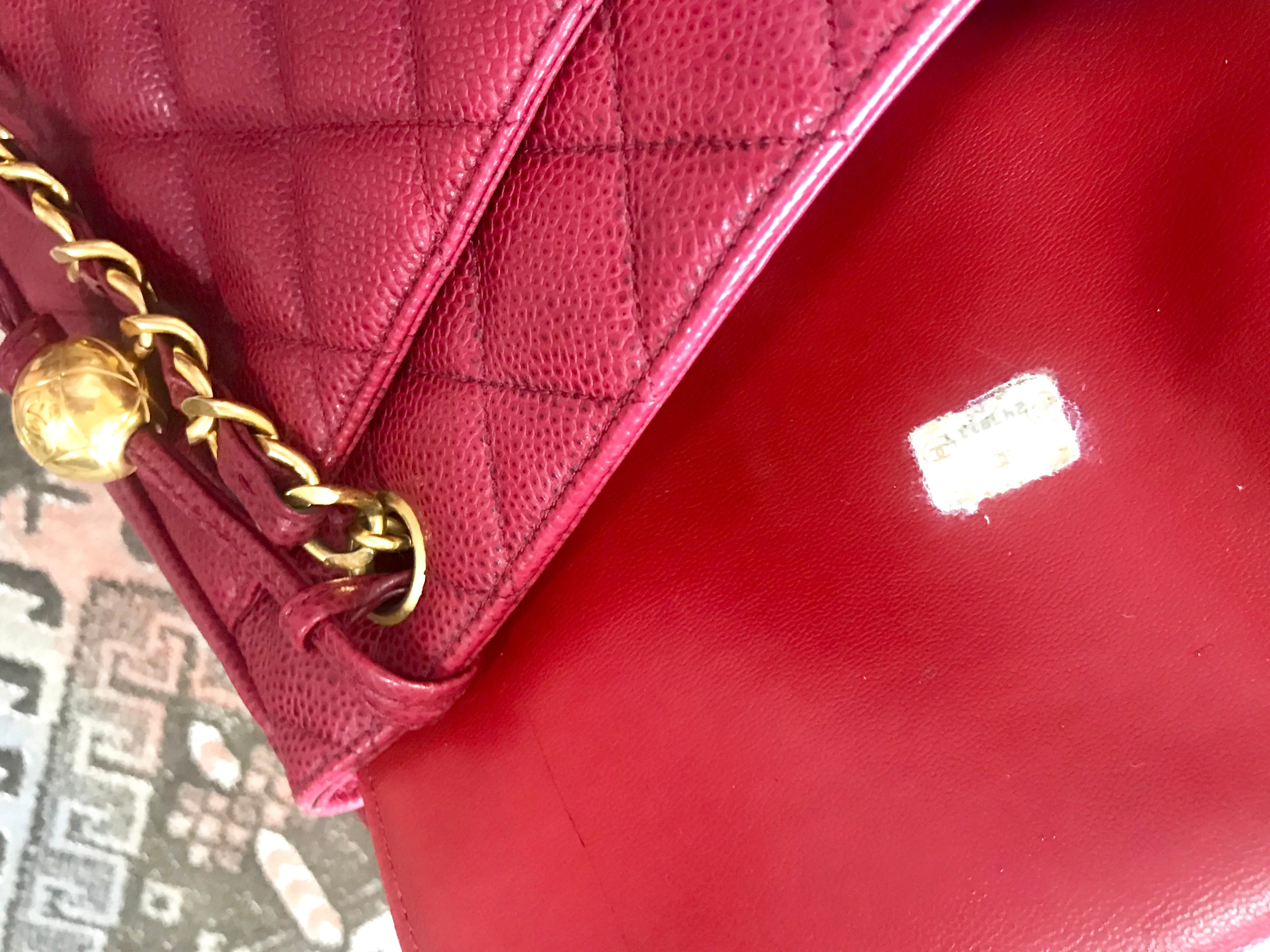 Vintage CHANEL cherry red caviar leather quilted shoulder bag, tote with golden CC ball and chain straps. Classic bag.
