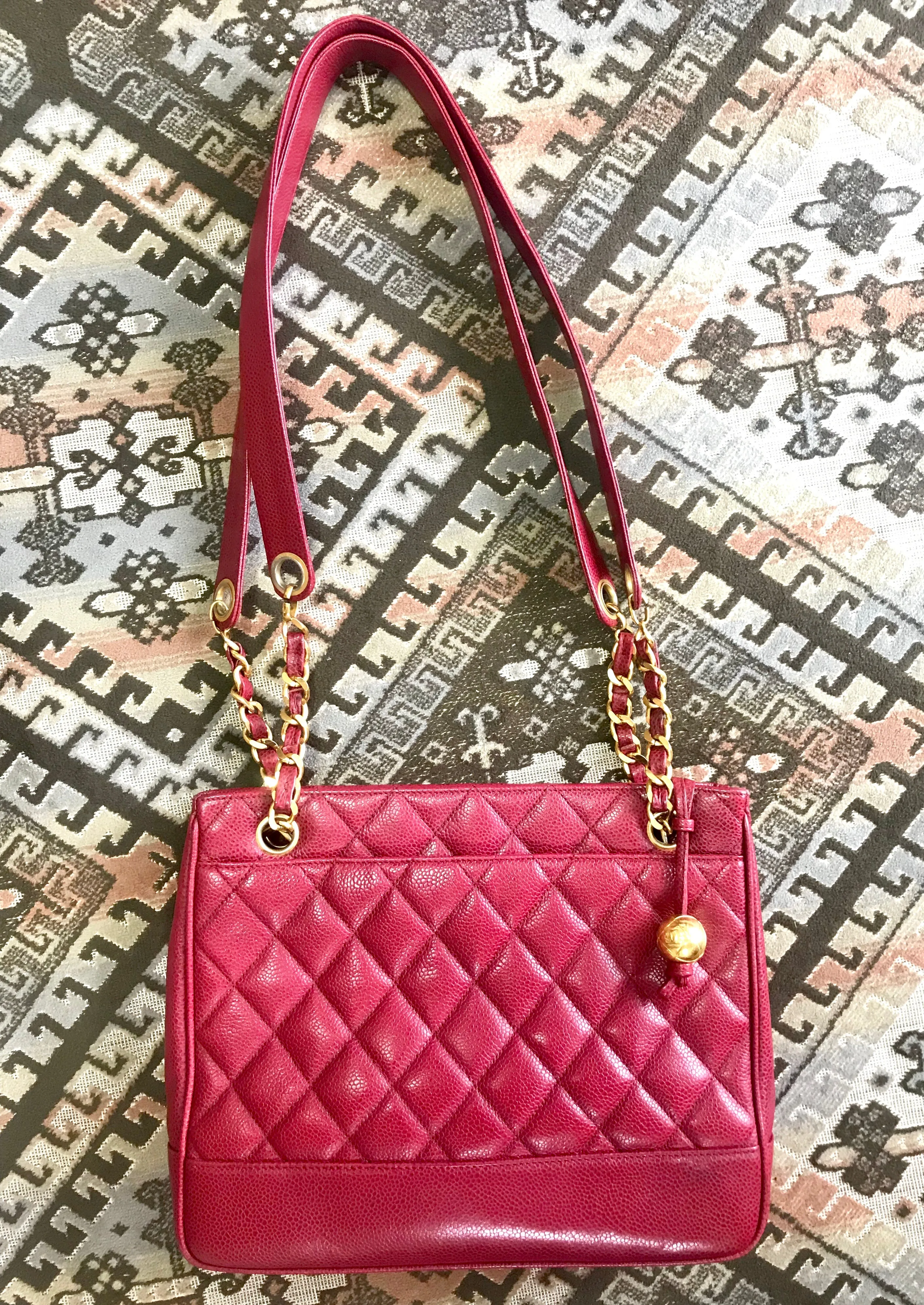 Vintage CHANEL cherry red caviar leather quilted shoulder bag, tote with golden CC ball and chain straps. Classic bag.